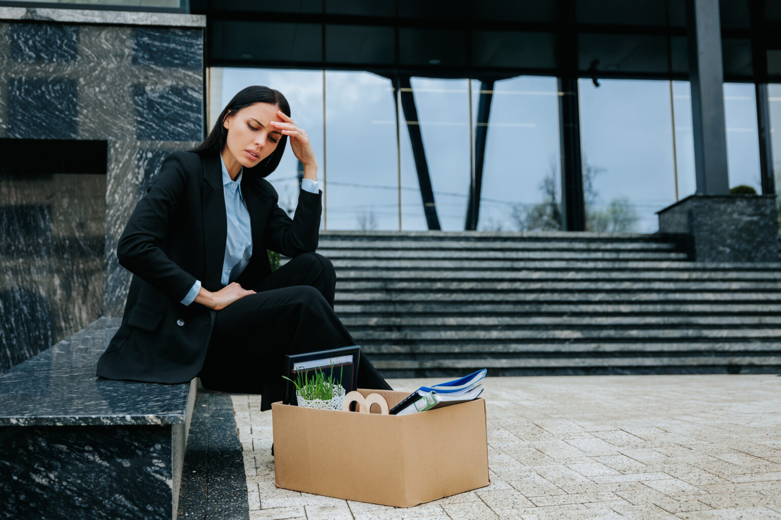 Feeling Lost And Upset After Being Fired, She Sits With Her Cardboard Box